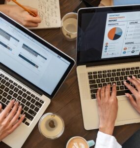 A young Nigerian entrepreneur working on a laptop, exploring digital business opportunities online.