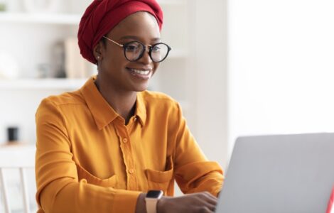 Young Nigerian freelancer working on a laptop at home in 2025