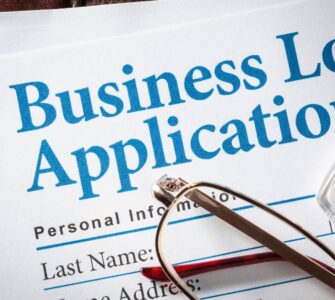 Business owner applying for a business loan in Nigeria in 2026 with documents and bank approval