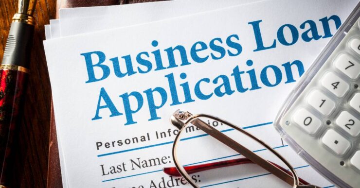 Business owner applying for a business loan in Nigeria in 2026 with documents and bank approval