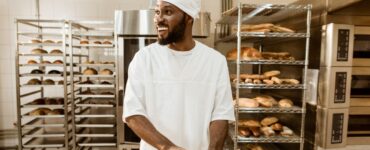 Bakery business challenges in Nigeria showing bakery owner managing equipment, flour, and power issues in a small bakery.