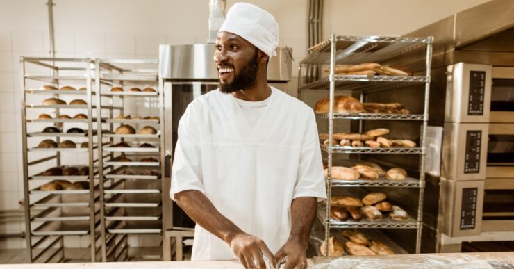 Bakery business challenges in Nigeria showing bakery owner managing equipment, flour, and power issues in a small bakery.