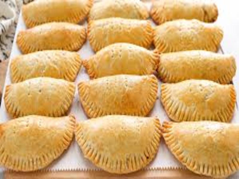Freshly baked Nigerian meat pies with golden crust